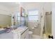 Cozy bathroom featuring a shower-tub combo and ample storage at 103 N Meteor Ave, Clearwater, FL 33765