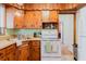 Charming kitchen features knotty pine cabinets and white appliances at 103 N Meteor Ave, Clearwater, FL 33765
