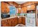 Charming kitchen features knotty pine cabinets and white appliances at 103 N Meteor Ave, Clearwater, FL 33765