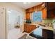 Traditional kitchen featuring wood cabinetry and white appliances at 103 N Meteor Ave, Clearwater, FL 33765