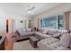 Open living room showcasing a large sectional sofa and plenty of natural light at 103 N Meteor Ave, Clearwater, FL 33765