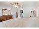 Bright main bedroom features light colored walls and furniture, and a ceiling fan at 103 N Meteor Ave, Clearwater, FL 33765