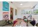 Sun room features tile flooring, indoor plants, and eclectic decor at 103 N Meteor Ave, Clearwater, FL 33765