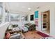 Sun room features tile flooring, eclectic seating, and lots of natural light at 103 N Meteor Ave, Clearwater, FL 33765