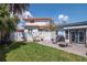 A fenced backyard with a small brick patio and neatly manicured lawn at 111 Chesapeake Ave, Tampa, FL 33606