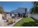 A well-kept backyard, featuring a grill, furniture, and vibrant greenery at 111 Chesapeake Ave, Tampa, FL 33606