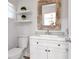 Updated bathroom with white vanity, framed mirror, and floating shelves at 111 Chesapeake Ave, Tampa, FL 33606