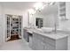 Bright bathroom with a double sink vanity, tiled floor, and a closet at 111 Chesapeake Ave, Tampa, FL 33606
