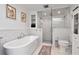 Bright bathroom featuring a soaking tub, glass shower, and subway tile at 111 Chesapeake Ave, Tampa, FL 33606