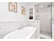 A luxurious bathroom featuring a soaking tub, and a large glass shower at 111 Chesapeake Ave, Tampa, FL 33606