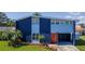 Modern two-story home showcasing a colorful exterior, a manicured lawn, and vibrant landscaping at 111 Chesapeake Ave, Tampa, FL 33606