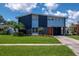 Striking two-story home features a modern design with lush landscaping, palm trees and a well-maintained lawn at 111 Chesapeake Ave, Tampa, FL 33606