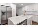Bright kitchen features quartz counters, stainless appliances, and white cabinetry at 111 Chesapeake Ave, Tampa, FL 33606