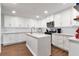 Modern kitchen featuring white cabinets, stainless steel appliances, an island, and granite countertops at 111 Chesapeake Ave, Tampa, FL 33606