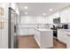 Bright kitchen featuring white cabinets, stainless steel appliances, island, and a modern design at 111 Chesapeake Ave, Tampa, FL 33606