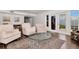 Open living room and sitting area with tile flooring, neutral walls, a glass table, and view to exterior at 111 Chesapeake Ave, Tampa, FL 33606