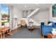 Cozy living room featuring stylish decor, wood flooring, a large window, and a staircase at 111 Chesapeake Ave, Tampa, FL 33606