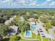 Aerial view of community pools, mature landscaping, and parking at 11764 Raintree Dr # 0, Temple Terrace, FL 33617