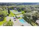 Aerial view of community pools, tennis courts, mature landscaping, and parking at 11764 Raintree Dr # 0, Temple Terrace, FL 33617