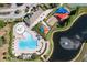 An aerial shot captures the community pool, playground, and a serene pond with a fountain at 11808 Holly Crest Ln, Riverview, FL 33569