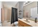 Bathroom with tile flooring, shower with curtain, single sink vanity, and decorative accent wall at 11808 Holly Crest Ln, Riverview, FL 33569