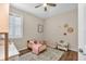 Cozy bedroom with wood floors, window with shutters, and a comfortable bed at 11808 Holly Crest Ln, Riverview, FL 33569