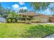 Well-maintained single-story home with green lawn, manicured hedges, and brick paver driveway at 11808 Holly Crest Ln, Riverview, FL 33569