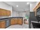 Open kitchen showcasing wooden cabinetry, stainless steel appliances, and a view into the adjacent living area at 11808 Holly Crest Ln, Riverview, FL 33569