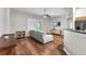Living room with wood floors, gray sofa, mounted television, and sliding glass doors to the exterior at 11808 Holly Crest Ln, Riverview, FL 33569