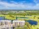 Stunning aerial view showcasing the condo community nestled within lush greenery and adjacent to scenic golf courses and waterways at 1200 Country Club Dr # 6302, Largo, FL 33771