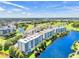 Scenic aerial view of multi-story condominium buildings with beautiful lakes and greenery in a desirable community at 1200 Country Club Dr # 6302, Largo, FL 33771