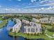 Scenic aerial view of condo community surrounded by golf courses, lakes, and lush greenery under a blue sky at 1200 Country Club Dr # 6302, Largo, FL 33771