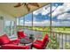 Inviting balcony with outdoor seating, showcasing picturesque views of the lake and lush greenery at 1200 Country Club Dr # 6302, Largo, FL 33771