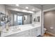 Bright bathroom featuring double sinks, modern vanity, and large mirror reflecting the bedroom at 1200 Country Club Dr # 6302, Largo, FL 33771