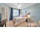 Bright bedroom featuring a ceiling fan, large window, and tasteful decor at 1200 Country Club Dr # 6302, Largo, FL 33771