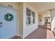 Inviting condo entrance with a decorative wreath on the door and a well-lit hallway at 1200 Country Club Dr # 6302, Largo, FL 33771