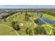 Expansive aerial view of a golf course featuring water hazards, sand traps, and green fairways at 1200 Country Club Dr # 6302, Largo, FL 33771