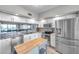 Well-lit kitchen with modern appliances, light cabinetry, and an island with wood top at 1200 Country Club Dr # 6302, Largo, FL 33771