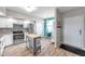 Modern kitchen with stainless steel appliances, white cabinetry, and an island with wooden countertop at 1200 Country Club Dr # 6302, Largo, FL 33771