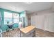 Charming kitchen with light blue accents, a center island, and an abundance of natural light at 1200 Country Club Dr # 6302, Largo, FL 33771