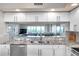 Modern kitchen with granite countertops, stainless steel dishwasher, and scenic view at 1200 Country Club Dr # 6302, Largo, FL 33771
