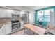 Bright kitchen with a chandelier, stainless steel appliances, and island with a butcher block top at 1200 Country Club Dr # 6302, Largo, FL 33771