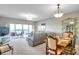 Bright living room with sliding glass doors to balcony, comfortable seating, and dining area at 1200 Country Club Dr # 6302, Largo, FL 33771