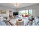Cozy living room with balcony access, comfortable seating, and a glimpse into the bedroom at 1200 Country Club Dr # 6302, Largo, FL 33771