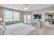 Serene main bedroom with a large window, ceiling fan, and access to the screened lanai at 1200 Country Club Dr # 6302, Largo, FL 33771