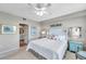 Bright bedroom with a comfortable bed, coastal decor, and an en-suite bathroom at 1200 Country Club Dr # 6302, Largo, FL 33771