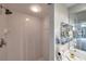 Clean white tiled shower with chrome fixtures and a view of the bathroom vanity area at 1200 Country Club Dr # 6302, Largo, FL 33771