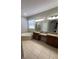 Bathroom with soaking tub, shower, dual sinks, vanity with granite counters, and tile flooring at 12631 Silverdale St, Tampa, FL 33626