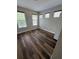 Bedroom featuring wood floors, neutral paint, and multiple windows at 12631 Silverdale St, Tampa, FL 33626