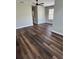 Open-concept living room featuring hardwood floors and a modern ceiling fan at 12631 Silverdale St, Tampa, FL 33626